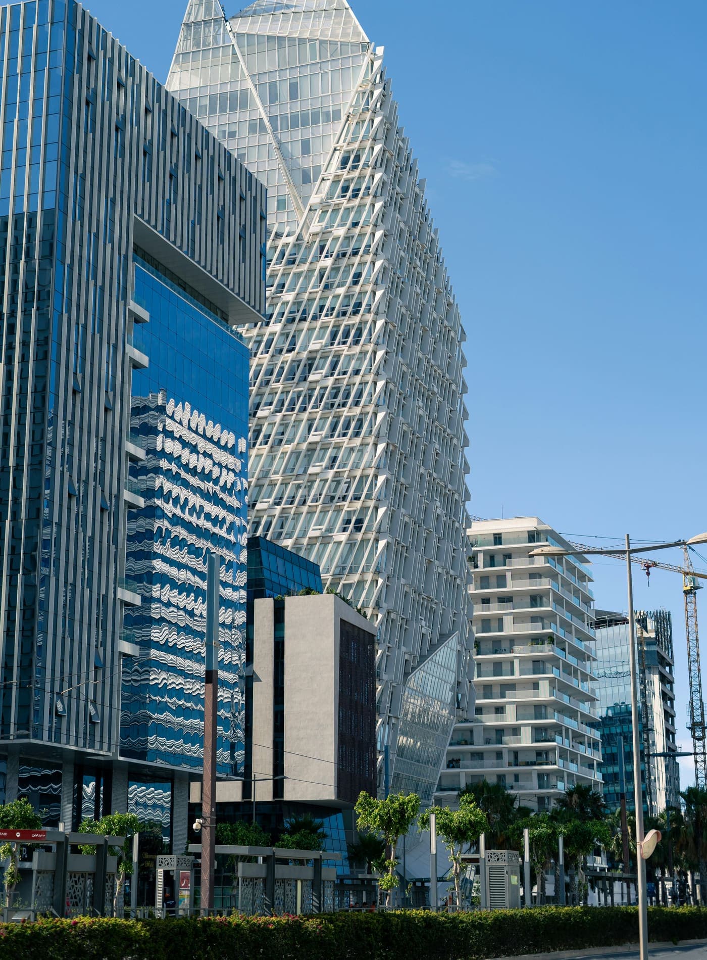 Les tours de Casablanca Finance City sous un ciel dégagé, vues depuis le boulevard.